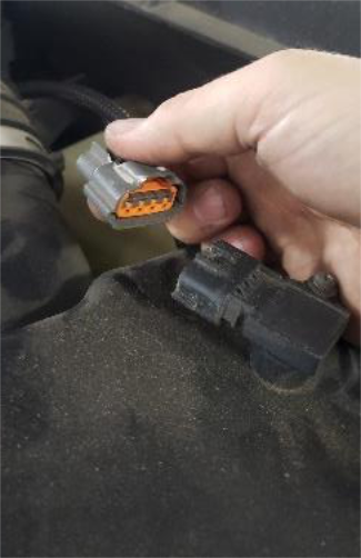 Unplug the grey connector on top of the filter housing