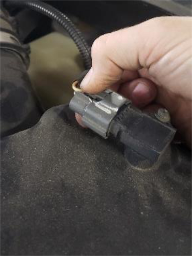 Unplug the grey connector on top of the filter housing