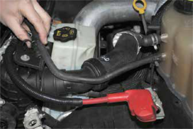 Reconnect the coolant line over the radiator to the degas bottle