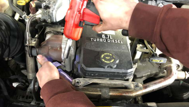 Loosen the V-band clamp on the far left of the EGR crossover tube