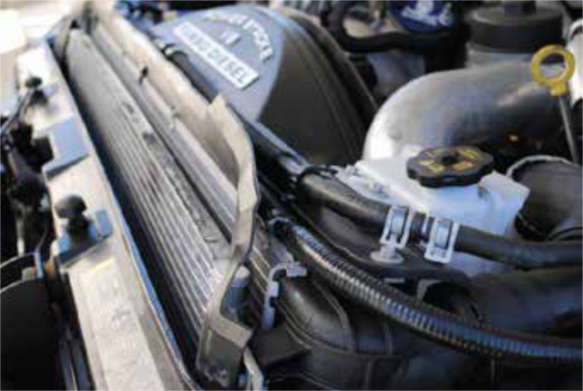 Reconnect the coolant line over the radiator to the degas bottle