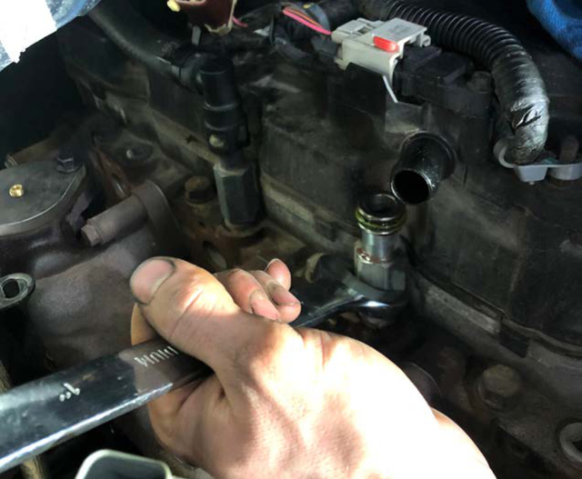 Remove the coolant nipple from the head and plug the hole