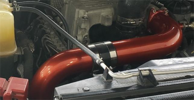 Bolt the charge tube to the manifold and lock the clamps