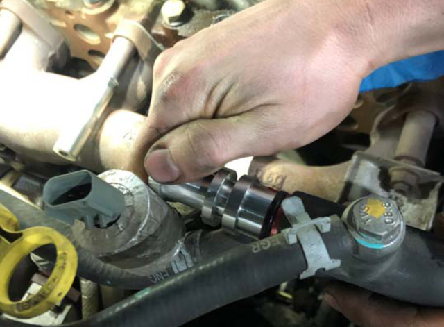 Attach the black steel bracket to the threaded collar and hose adapter