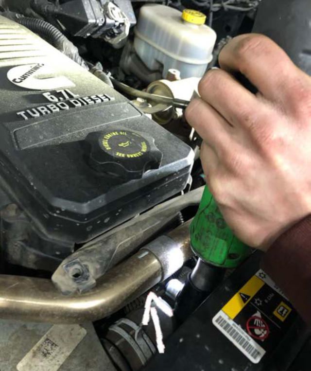 Remove the 8mm bolt between the crossover tube and the radiator hose