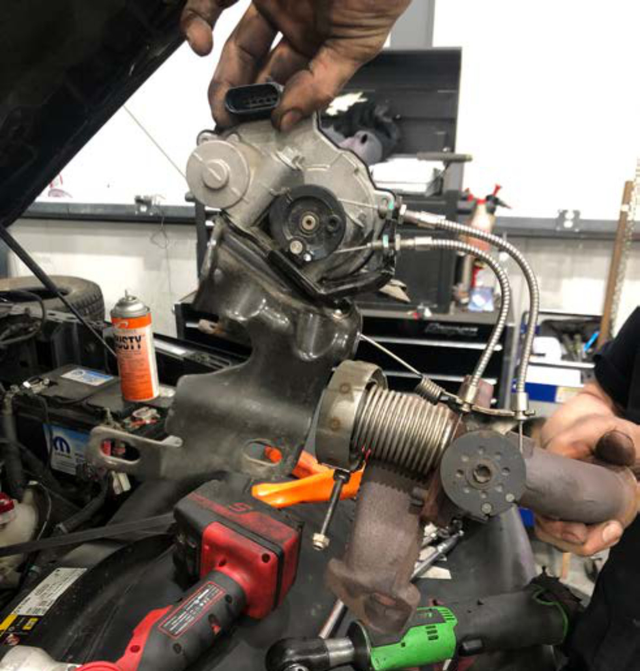 Pull off the bypass valve assembly with the front section of cooler plumbing