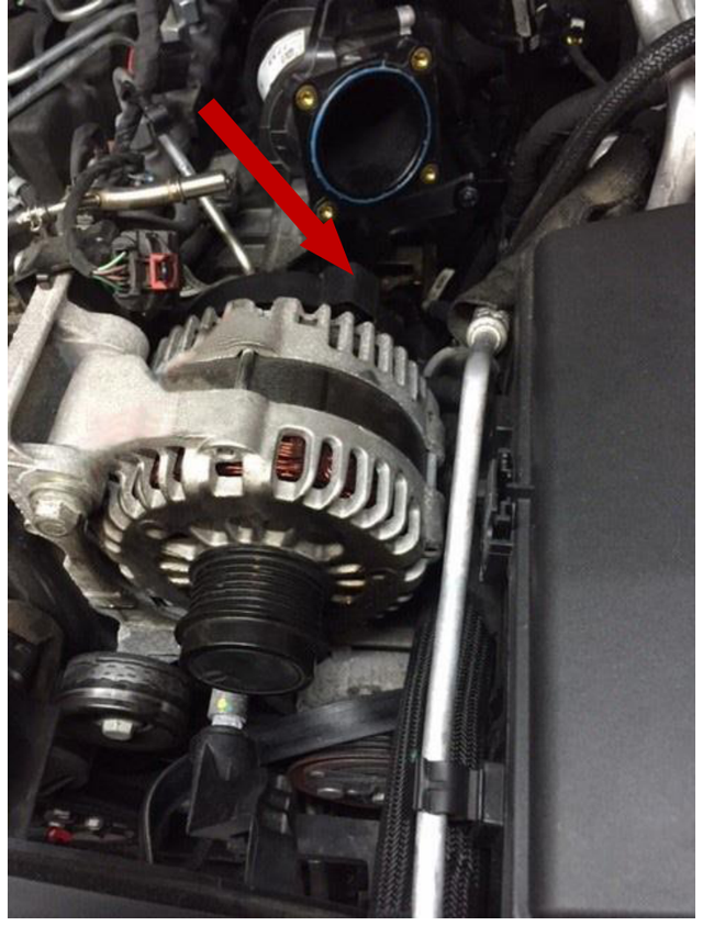 Unplug the connector on the top back of the alternator