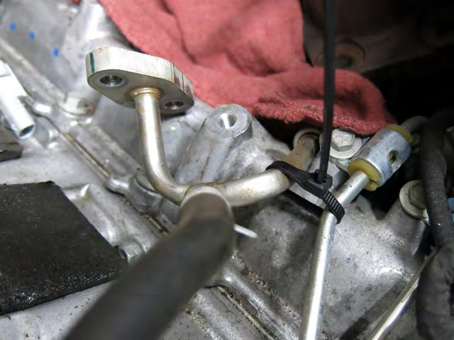 Remove the turbo coolant feed and return lines