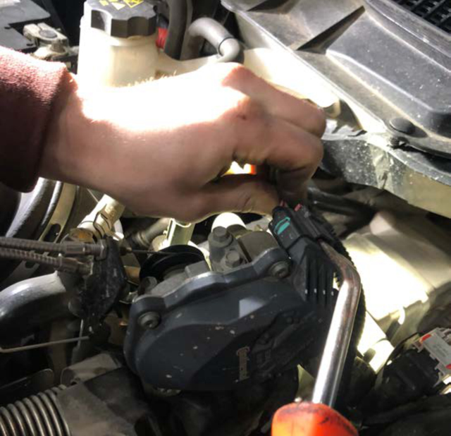 Unplug the black connector on the EGR cooler servo assembly