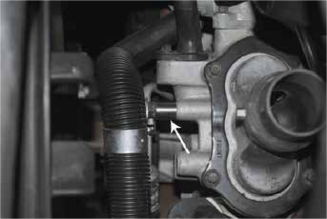 Reinstall the stud with the supplied spacer and secure the power steering line to it