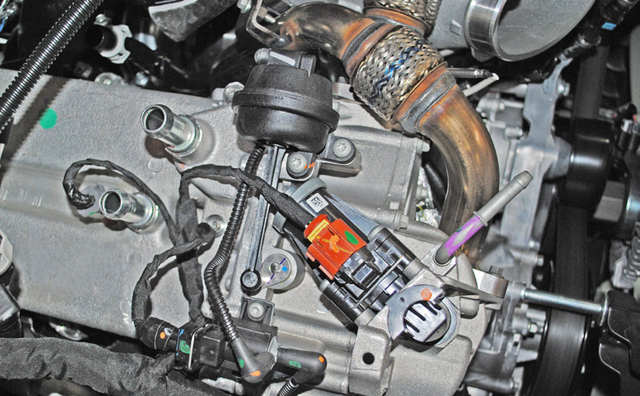 Unplug the harnesses on top of the EGR cooler and cap the vacuum line